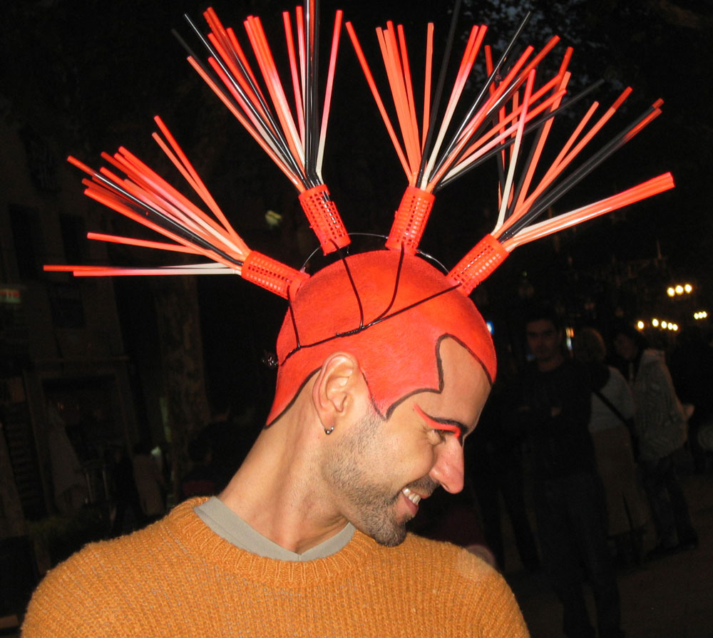 A man with an orange mohican shows off to the camera